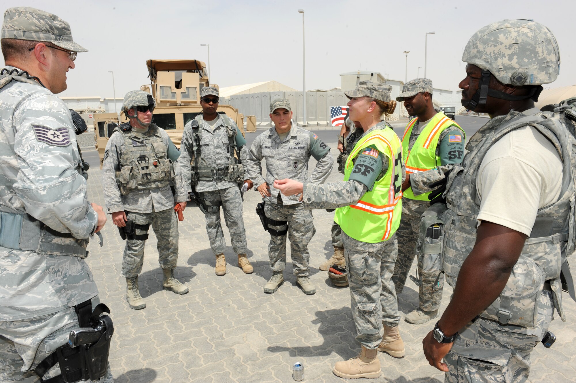 SOUTHWEST ASIA - U.S. Air Force Staff Sgts. Valerie Queitzsch and Hakim Taylor, 380th Expeditionary Security Forces Squadron Exercise Evaluation Team members, debrief 380th ESFS Quick Response Force members after an active-shooter exercise July 31, 2012. Exercise evaluation teams observe exercise situations and provide participants with feedback on how to improve responses to similar situations. (U.S. Air Force photo/Master Sgt. Scott MacKay)