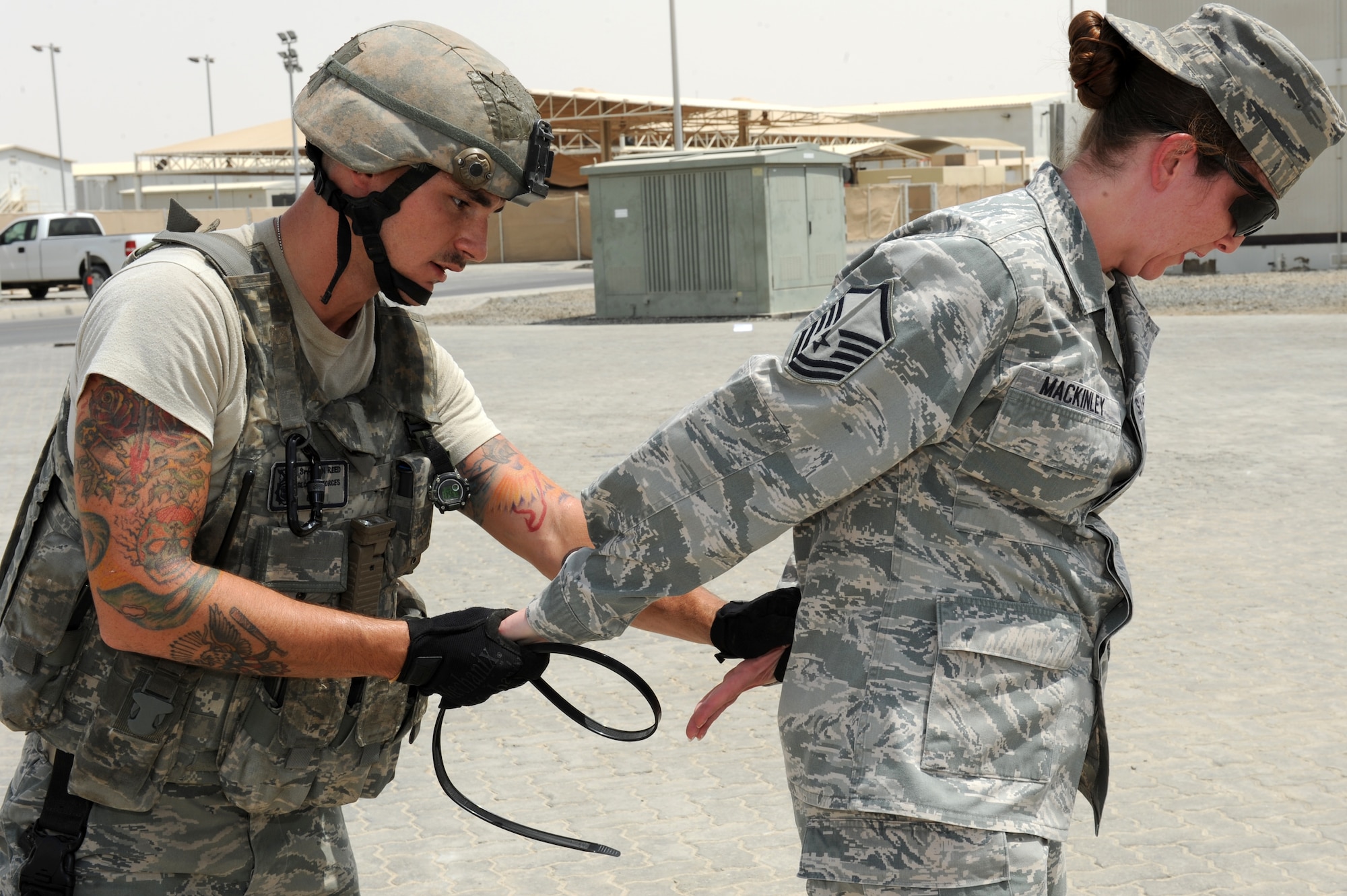SOUTHWEST ASIA - U.S. Air Force Senior Airman Jon Reed, 380th Expeditionary Security Forces Squadron Quick Response Force member, arrests Master Sgt. Jaclyn MacKinley, 380th Air Expeditionary Wing superintendent of wing staff executive services, during an active-shooter exercise July 31, 2012. Active-shooter exercises test the base's response to a hostile threat. (U.S. Air Force photo/Master Sgt. Scott MacKay)