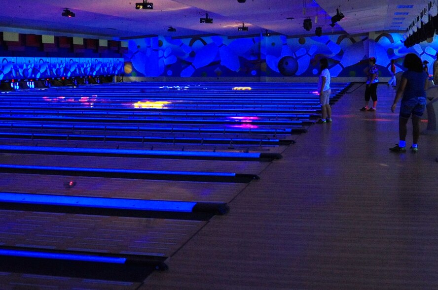Members of Misawa Air Base, Japan, bowl at the Walmsley Bowling Center, August 1, 2012.  The bowling center is one of the few air-conditioned facilities on base for members to use.  The center has lower prices compared to off-base bowling centers.  Some promotions include free bowling and shoe rentals Mondays through Thursdays from 11 a.m. to 2 p.m.  Play a third game free on Big Bowl Saturdays, 12 p.m. to 6 p.m.  The center also offers discounts to families on Sundays.  (U.S. Air Force photo by Staff Sgt. April Quintanilla)