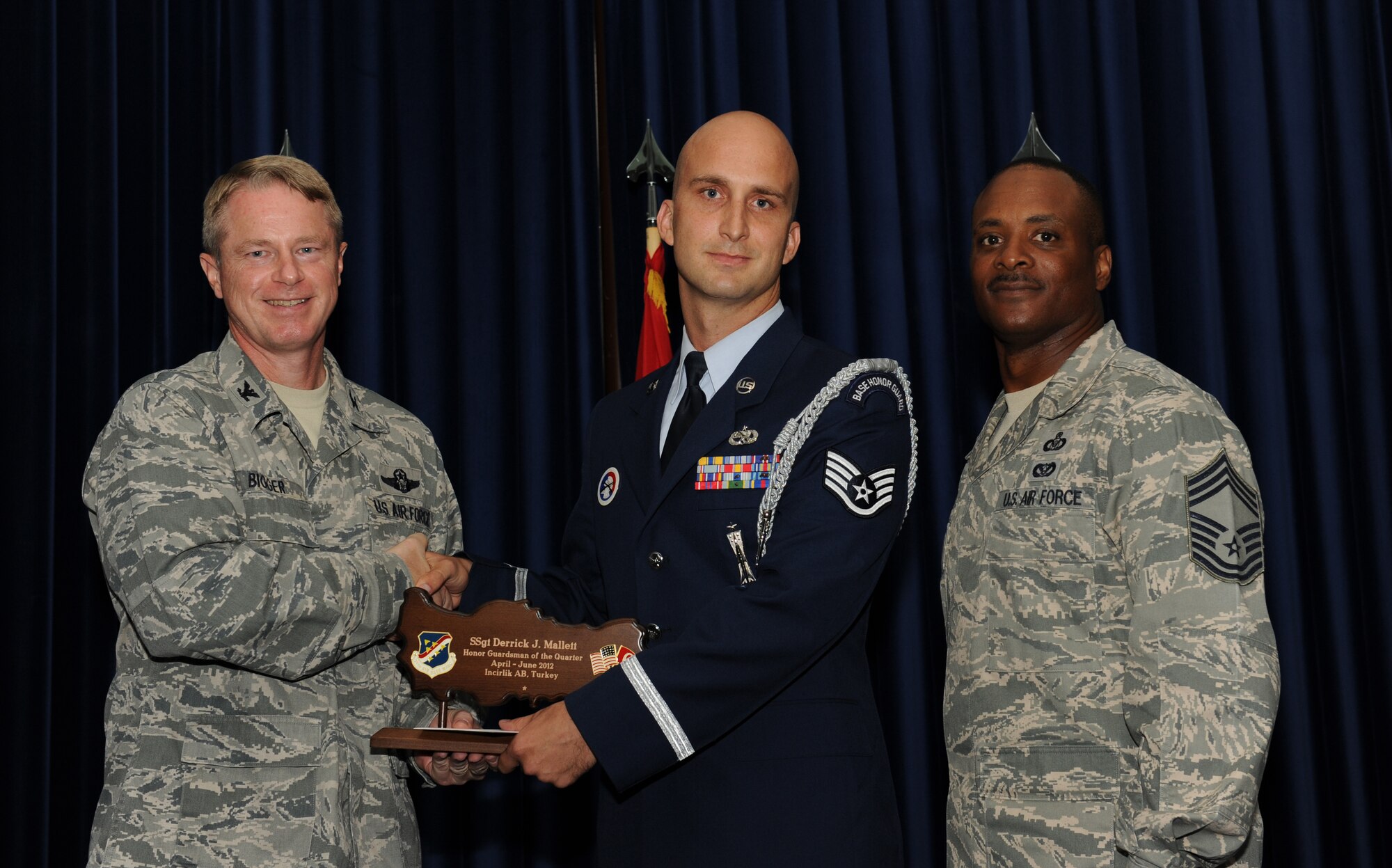 Staff Sgt. Derrick Mallett, 39th Maintenance Squadron, receives the 39th Air Base Wing Honor Guardsman of the Quarter Award July 31, 2012, at the Club Complex ballroom at Incirlik Air Base, Turkey. (U.S. Air Force photo by Senior Airman Jarvie Z. Wallace/Released)