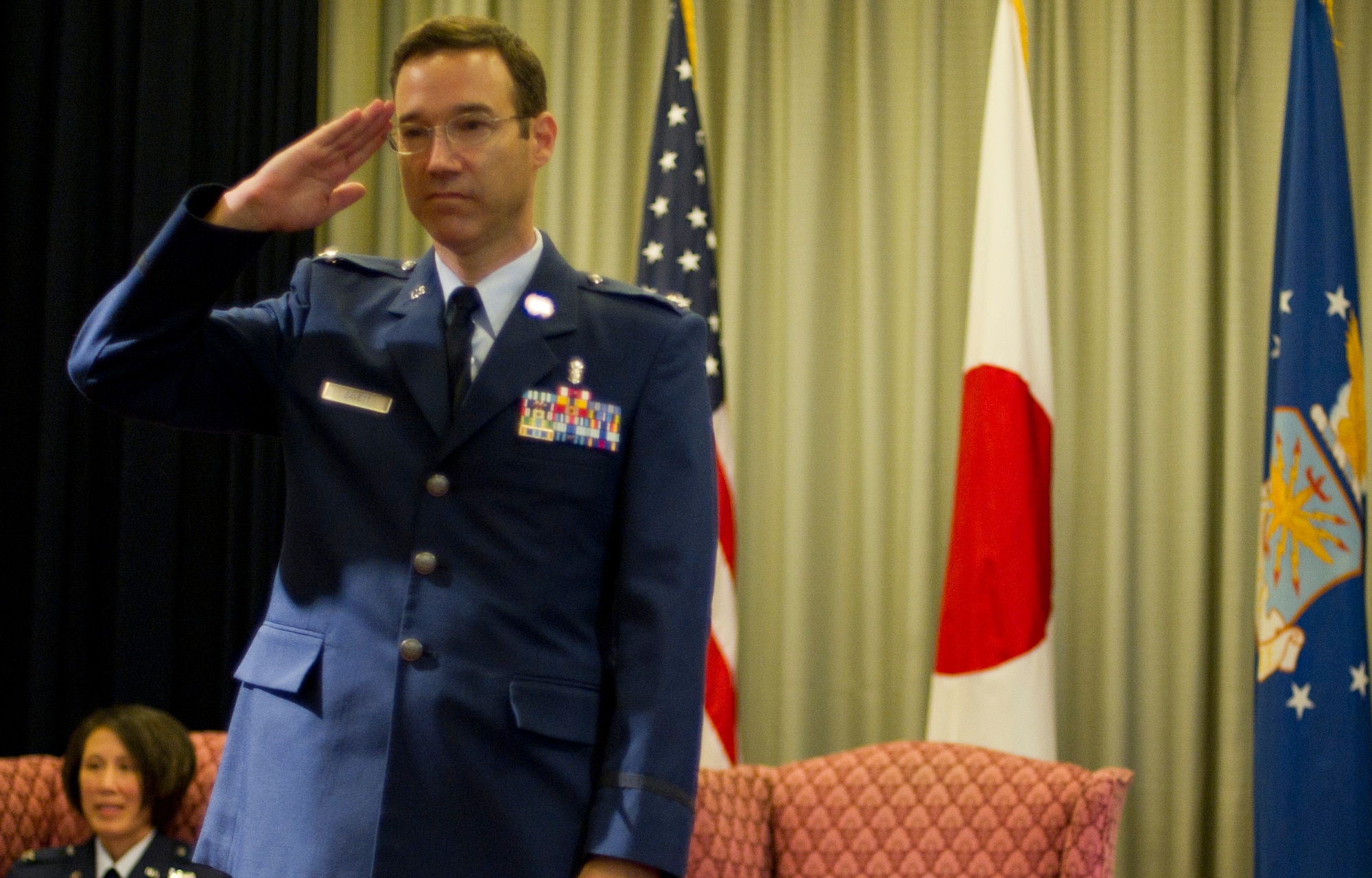 YOKOTA AIR BASE, Japan -- Col. Daniel Savett, 374th Dental Squadron commander, salutes members of his squadron for the first time during the 374 DS change of command ceremony July 27, 2012, at Yokota Air Base, Japan. The tradition of the military salute can be traced back to medieval knights raising their visors when passing their superiors. This age-old gesture is a universal symbol of mutual respect. (U.S. Air Force photo by Staff Sgt. Stacy Moless)