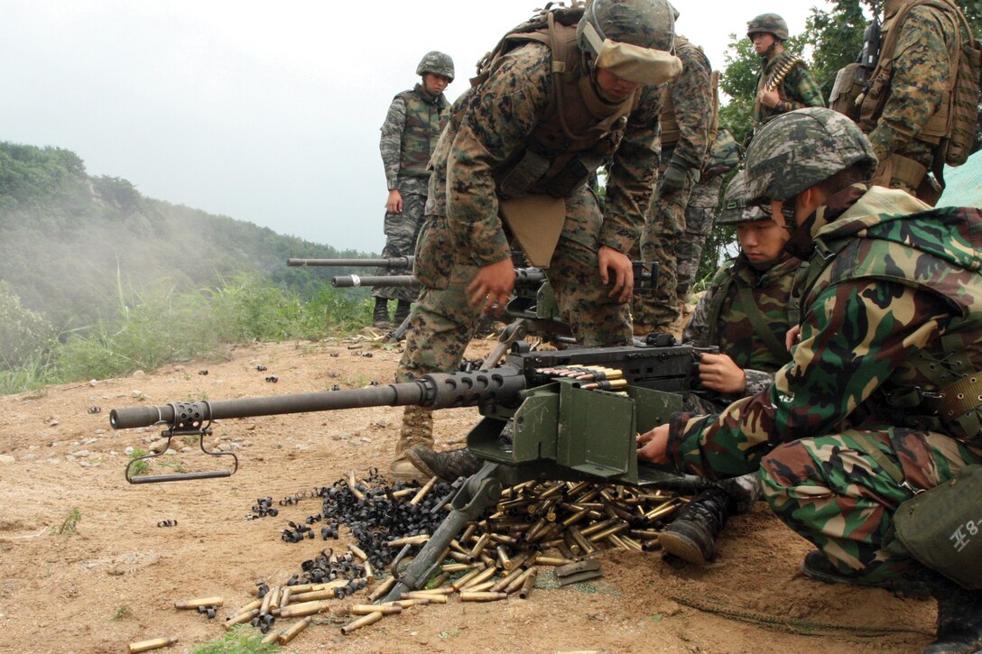 ROK and U.S. Marines observe as Lance Cpl. Park Seung Yeon fires the M2 .50-caliber Browning machine gun July 23 at Nightmare Range, Republic of Korea, during Korean Marine Exchange Program 12-7. Yeon is with 8th Artillery Battalion, 2nd ROK Marine Division. The U.S. Marines are with 12th Marine Regiment, 3rd Marine Division, III Marine Expeditionary Force.
