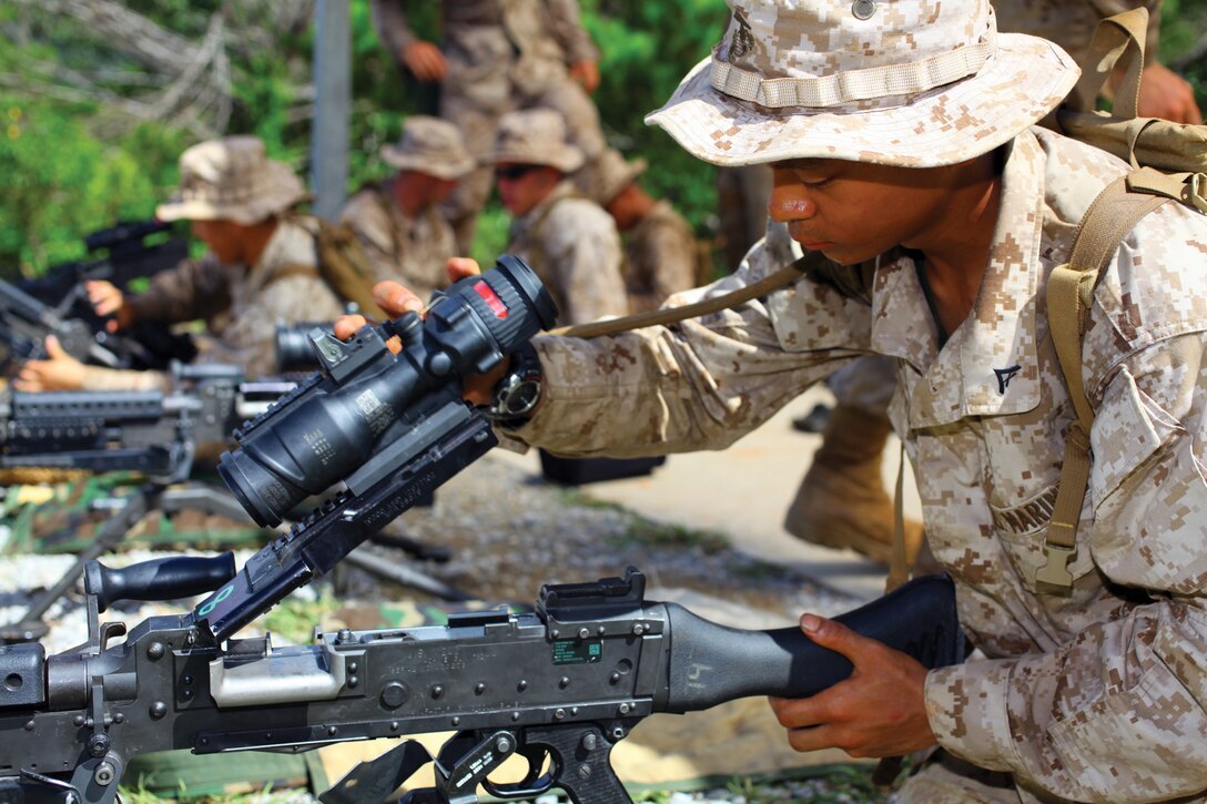 Lance Cpl. Ryan J. Pechay disassembles an M240B medium machine gun during security-operations training at Camp Schwab July 20. Pechay is an automotive maintenance technician with Headquarters Battalion, 3rd Marine Division, III Marine Expeditionary Force.