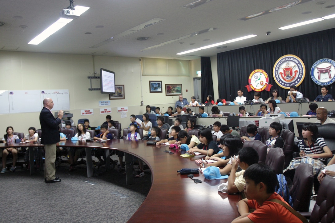 Elementary school students listen to Dr. Robert D. Eldridge July 25 at Camp Foster. The students’ visit was part of the schools’ three-year project and study trip, which the board of education hopes will show the students the importance of peace. The students are from Iitate Village in Fukushima Prefecture, Japan. Eldridge is the deputy assistant chief of staff, G-7, government and external affairs office.