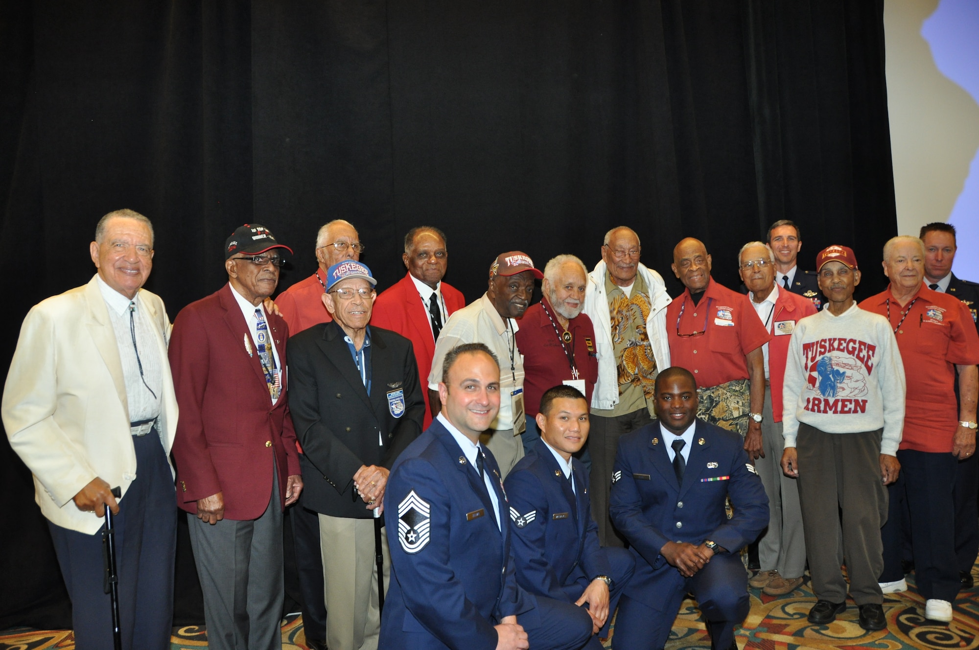 Tuskegee Airmen assigned to the 477th Bombardment Group and current members of the 477th Fighter Group from Joint Base Elmendorf-Richardson, Alaska gather for a group photo. During the 41st Annual Tuskegee Airmen Convention Military luncheon Col. Bryan Radliff, 477th Fighter Group commander announced that Air Force Chief of Staff Gen. Norton Schwartz had recognized and simultaneously retired the 477th Bombardment Group emblem to the Air Force Historical Research Agency for inclusion in the organizations official heraldry records. (U.S. Air Force Photo/Capt. Ashley Conner) 