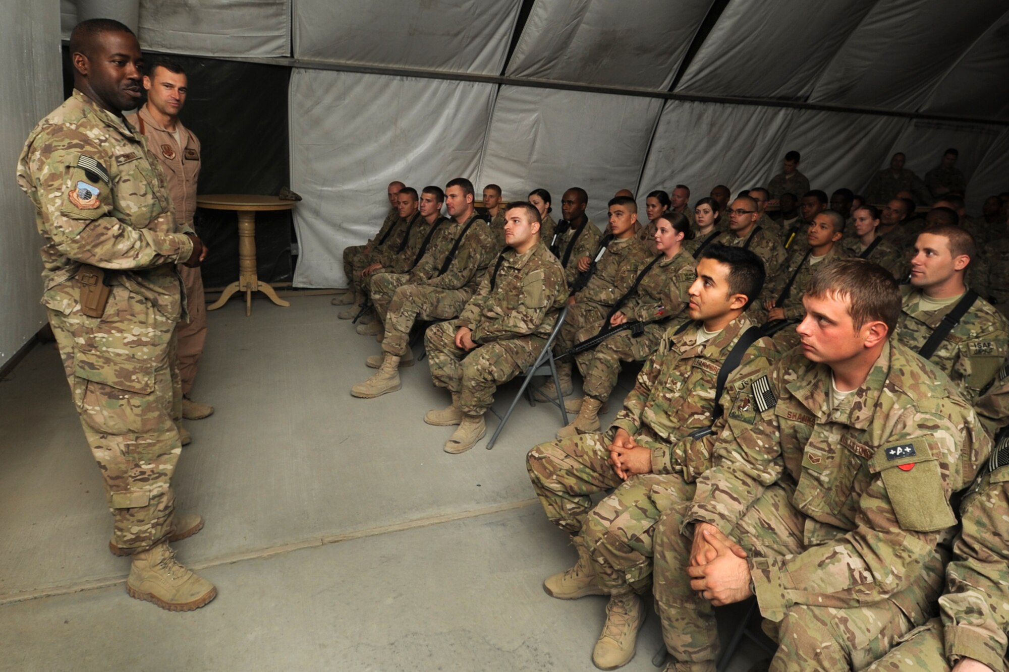 CMSgt Marcus Snoddy, 455th Air Expeditionary Wing commander AEW Commander Chief Master Sergeant, addresses 455 AEW Senior Airmen selected for promotion to Staff Sergeant at Bagram Airfield, Afghanistan, 2 August, 2012. A total of 98 455 AEW Airmen were chosen to become non-commissioned officers. "This is a very significant day for these Airmen. This is the beginning of a new juncture in their lives," said Snoddy. "They are transitioning from the Airman tier to the NCO tier. They are about to be the rubber that meets that road, leading as first line supervisors. They are going to be responsible for growing and developing Airmen." (U.S. Air Force Photo/SSgt Jeff Nevison)