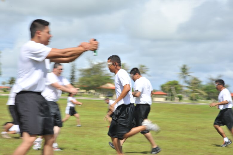 ANDERSEN AIR FORCE BASE, Guam-Department of Defense police officer cadets train with Oleoresin Capsicum Spray through a five-station obstacle course for qualification here July 27. After completing the course, the recruits will become DoD police officers for Andersen AFB and security guards for Naval Base Guam. This training is required so officers get first-hand experience using the weapon and can still perform their duties if they are sprayed during an incident. The academy is nine weeks for DoD police officer’s and five weeks for the security guards. The current class consists of 18 police officers and two security guards. Upon completion, 17 DoD police officers will be assigned to Andersen. This program was postured to enhance the security of the installation and ensure qualified personnel are manning the gates and patrols. (U.S. Air Force Photo by Staff Sgt. Alexandre Montes/RELEASED) 