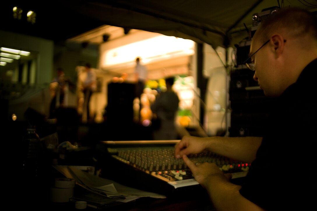 FUSSA, Japan -- Senior Airman Brian Lumpkin, Band of the Pacific-Asia audio engineer, mixes Final Approach  on provided equipment at the Tanabata Festival, Fussa, Japan, Aug. 2, 2012. Lumpkin was able to mix on unfamiliar equipment due to his knowledge and training. (U.S. Air Force photo/Staff Sgt. Josh Voyles)