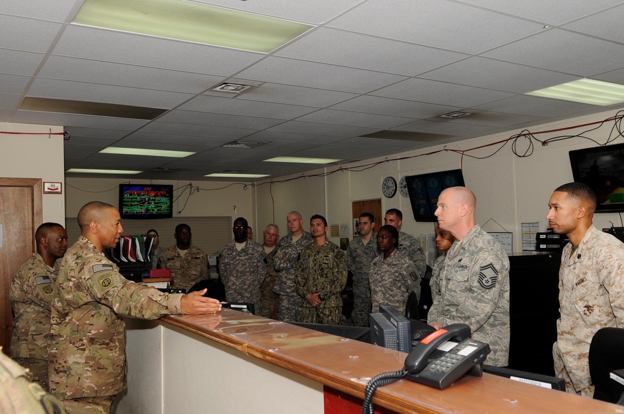 Army Command Sgt. Maj. Thomas Capel, International Security Assistance Force and United States Forces – Afghanistan senior enlisted advisor speaks to Soldiers, Sailors, Airmen, and Marines assigned to the Joint Mobility Control Center during a tour of the Transit Center at Manas, Kyrgyzstan, Aug. 1, 2012. The JMCC is responsible for ensuring the travel arrangements for U.S. and coalition forces heading to and from the area of operations goes smoothly. Capel spent the day learning about the different mission functions of the Transit Center and had the opportunity to thank all the service members assigned for their hard work, sacrifices and dedication to support the ISAF mission. (U.S. Air Force photo/Master Sgt. Jason Vaught)