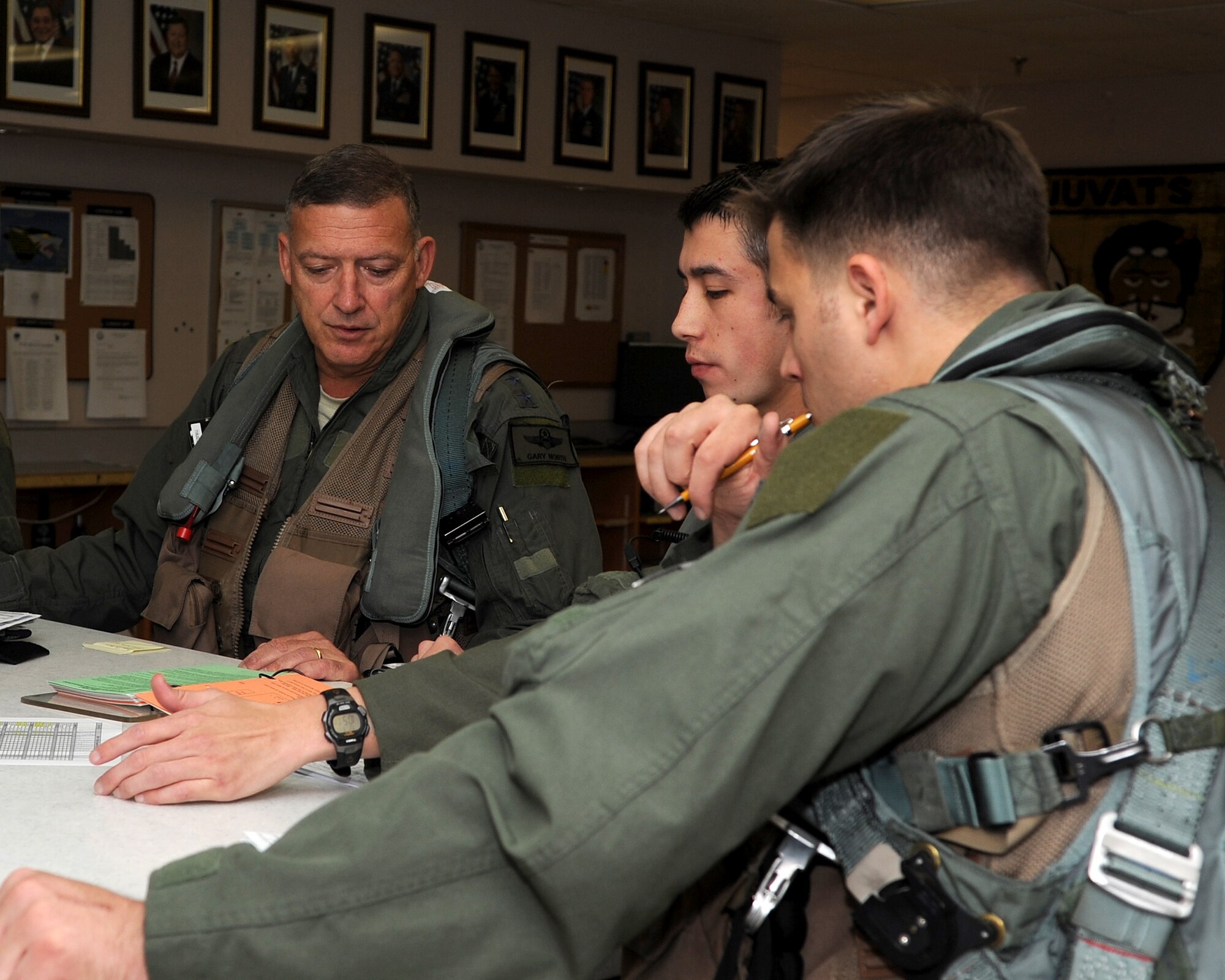 Gen. Gary North, Pacific Air Forces commander, receives a pre-flight briefing for one of his final flights at Kunsan Air Base, Republic of Korea, July 17, 2012. The flight was part of North's final visit to the base before his upcoming retirement after 36 years of service. (U.S. Air Force photo/Staff Sgt. Jonathan Fowler)