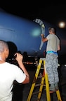 ANDERSEN AIR FORCE BASE, Guam -- Staff Sgt. Oliver Johnson, 36th Expeditionary Aircraft Maintenance Squadron crew chief, holds the flashlight while Airman 1st Class Bruce Brimm, 36th EAMXS crew chief, inspects the exterior of a B-52 Stratofortress here July 31. The 36th EAMXS Airmen make sure the B-52 is ready for the flight in support of the Rim of the Pacific Exercise. (U.S. Air Force photo by Airman 1st Class Marianique Santos/Released)