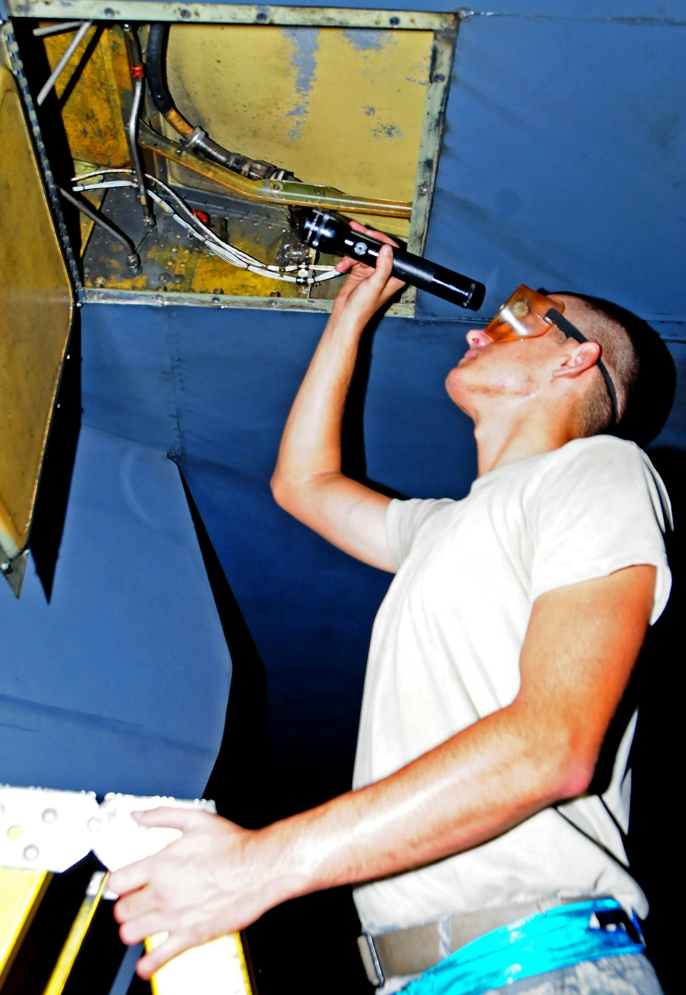 ANDERSEN AIR FORCE BASE, Guam -- Airman 1st Class Bruce Brimm, 36th Expeditionary Aircraft Maintenance Squadron crew chief, checks the panels underneath the wing of a B-52 Stratofortress here July 31. The 36th EAMXS Airmen make sure the B-52 is ready for the flight in support of the Rim of the Pacific Exercise. (U.S. Air Force photo by Airman 1st Class Marianique Santos/Released)