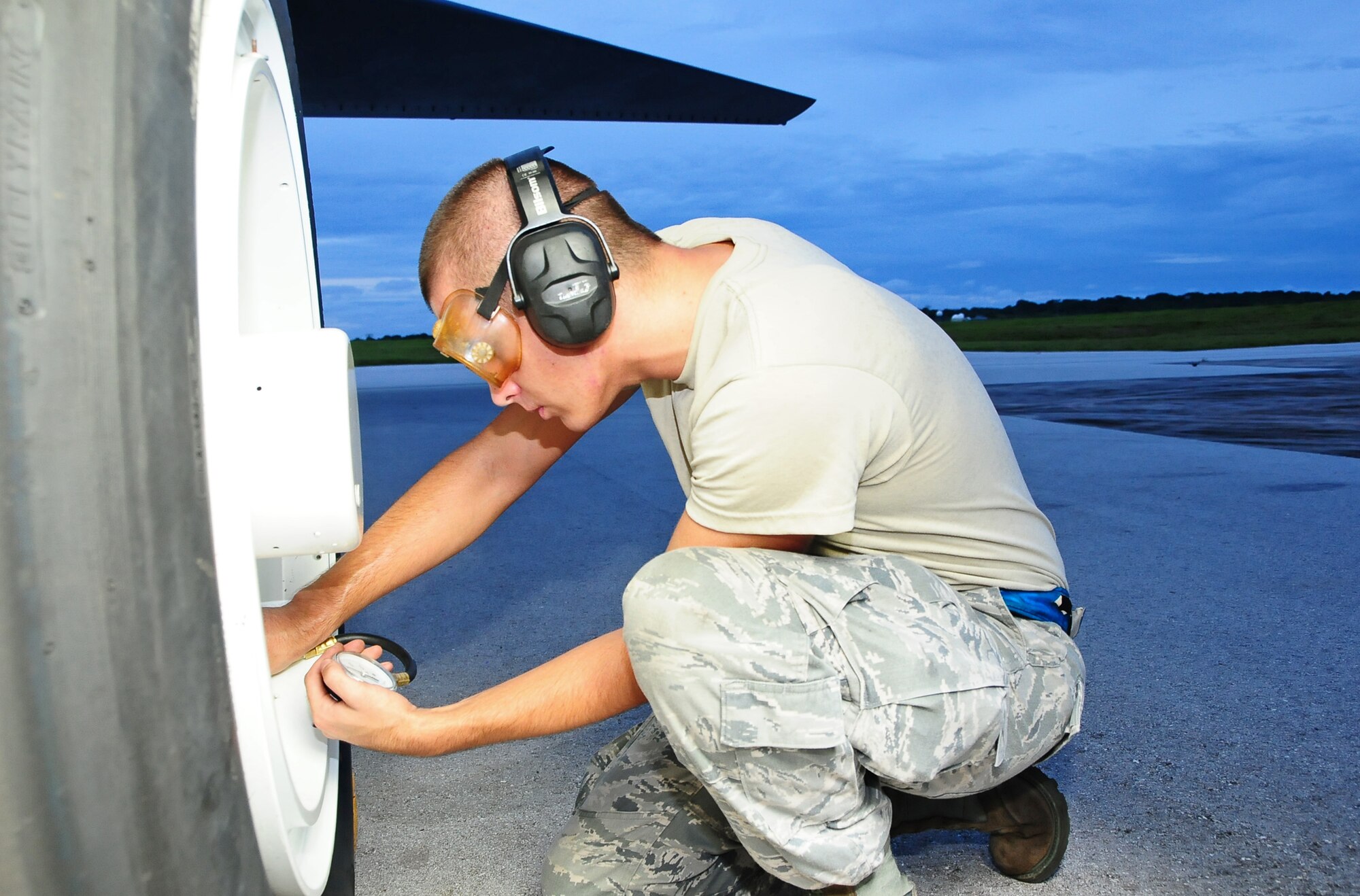 ANDERSEN AIR FORCE BASE, Guam -- Airman 1st Class Bruce Brimm, 36th Expeditionary Aircraft Maintenance Squadron crew chief, checks the tire pressure on the B-52 Stratofortress during a pre-flight inspection here July 31. The 36th EAMXS Airmen make sure the B-52 is ready for the flight in support of the Rim of the Pacific Exercise. (U.S. Air Force photo by Airman 1st Class Marianique Santos/Released)