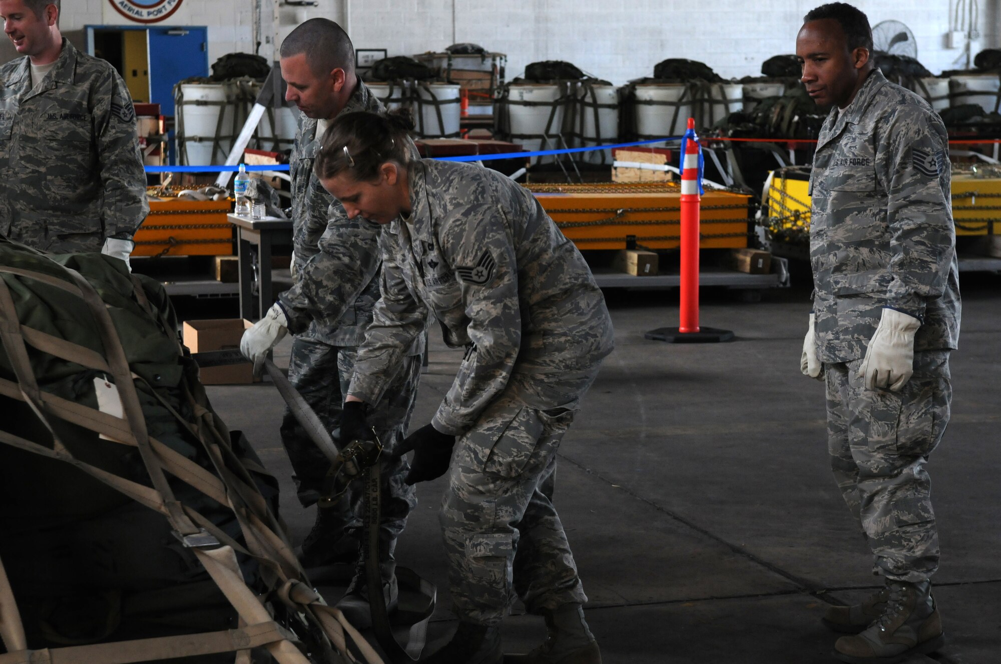 Technical Sgt. Leslie Cook, center, 166th Logistics Readiness Squadron, instructs fellow unit Airmen on cargo pallet build-up for the C-130 transport aircraft in the small air terminal at the New Castle Air National Guard Base, Del. on June 3, 2012. The training is preparation for the 166th Airlift Wing's Air Force Operational Readiness Inspection which starts on August 3. (U.S. Air Force photo/Airman 1st Class Weslyn White-Kelly)