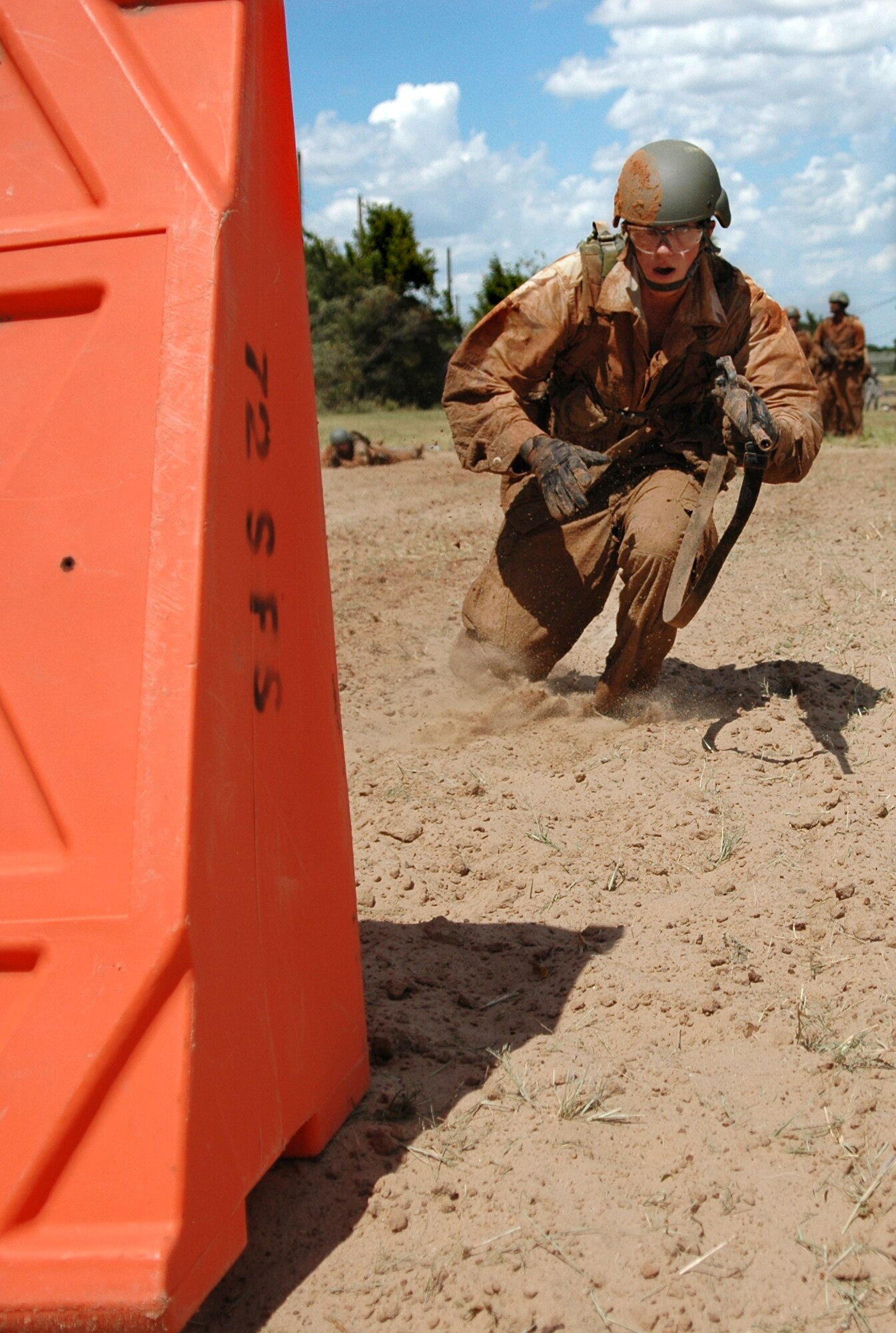 Airman 1st Class Robert Meyer, 32nd Combat Communications Squadron bounds from obstacle to obstacle during the “rush-and-roll” portion of the Individual Movement Techniques Course at the 3rd CCG Combat Readiness School. (Air Force photo by Micah Garbarino)