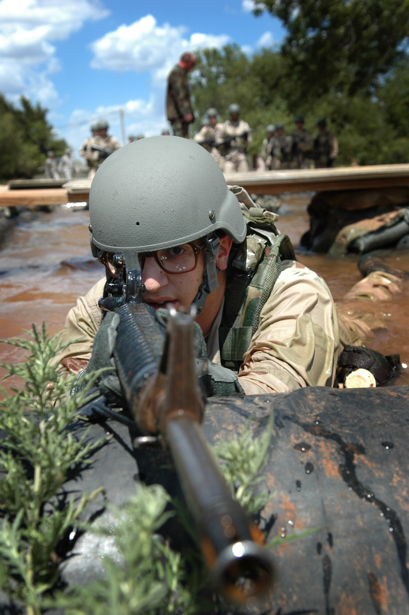 After the classroom session Airman Ramirez-Dominguez takes up a defensive position while he waits for his fire team on the Individual Movement Course.(Air Force photo by Micah Garbarino)