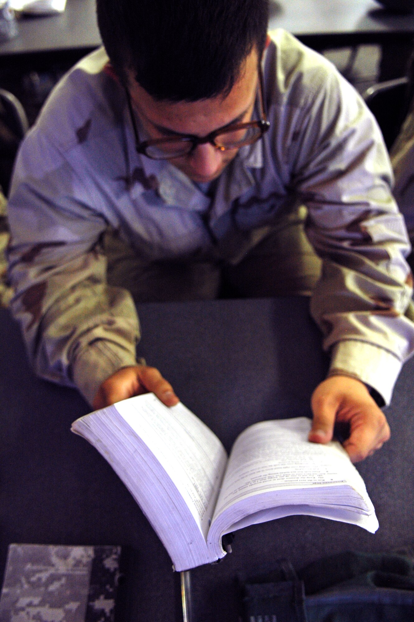 Airman 1st Class Carlos Ramirez-Dominguez studies a combat handbook during the Individual Movement Techniques Classroom session at 3rd Communications Group Combat Readiness School July 25. Airman Ramirez-Dominguez and his classmates made up “Omega” class. The final group of Airman to go through the school before the 3rd Herd leaves Tinker.(Air Force photo by Micah Garbarino