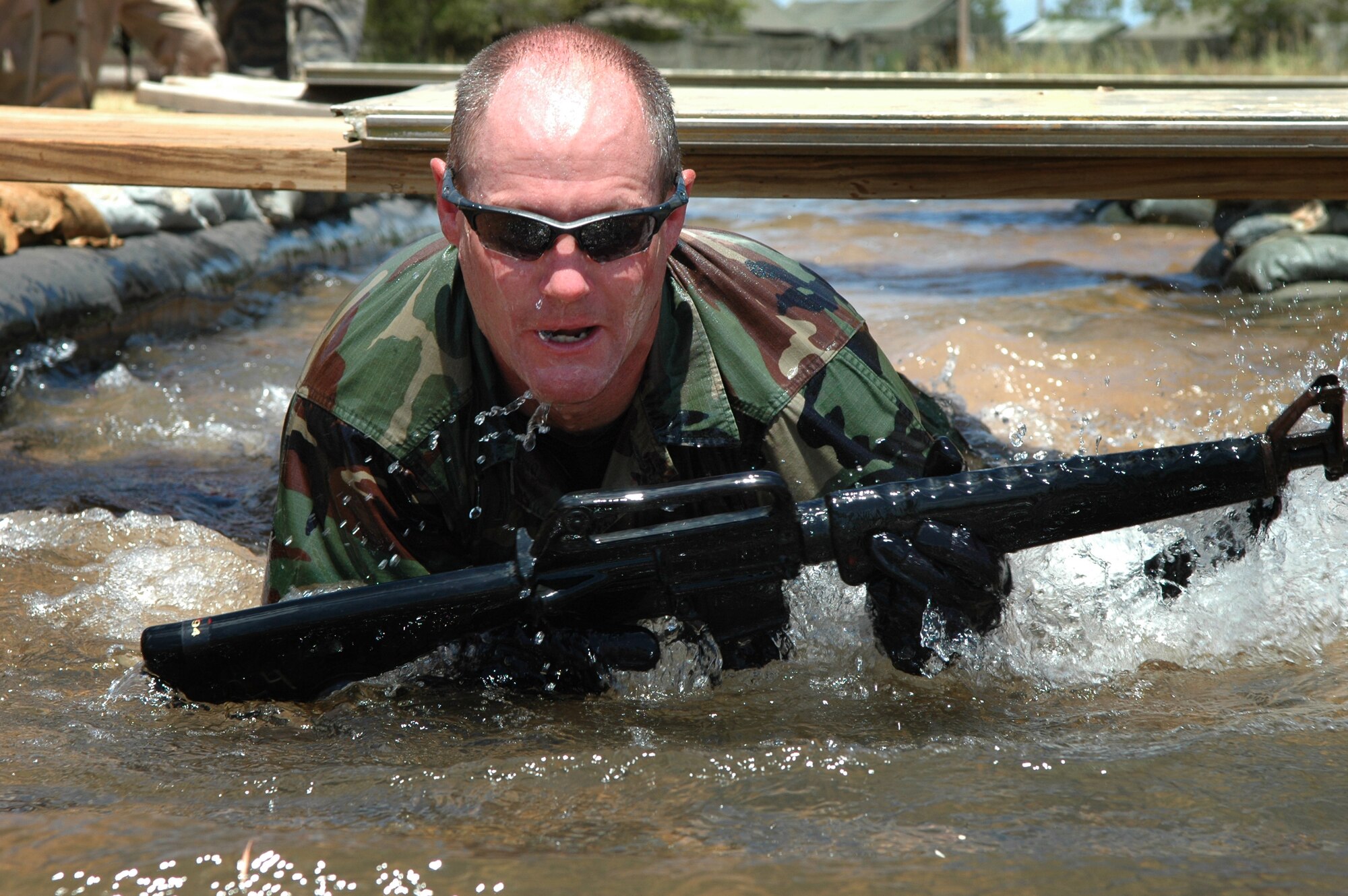 Master Sgt. Matt Smith, 3rd Combat Communications Group, Combat Readiness School commandant, demonstrates movement techniques on the Individual Movement Course. The 3rd CCG completed its final class recently. (Air Force photo by Micah Garbarino)