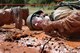 Air Force Academy Cadet 2nd Class Josh Beaker squirms through the mud in a line of fellow classmates at the 3rd CCG’s Combat Readiness School July 25. Cadet Beaker, and other Academy cadets, took part in the school’s final class. (Air Force photo by Micah Garbarino)