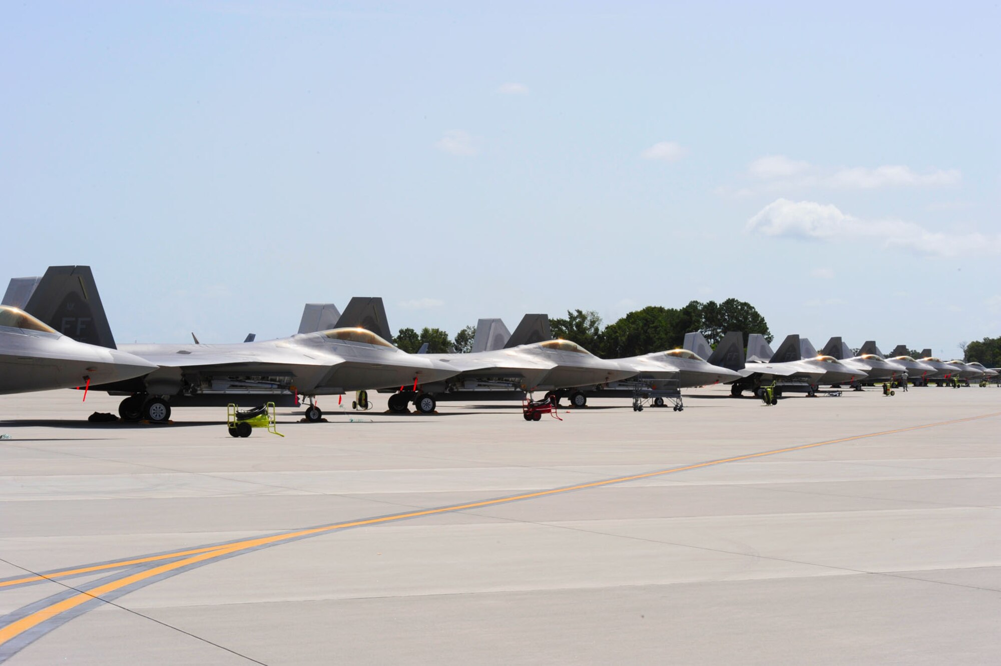F-22 Raptors from the 94th Fighter Squadron await maintenance on the ramp at the Combat Readiness Training Center in Savannah, Ga., July 23, 2012. Personnel from the 1st Fighter Wing are currently partnering with the Georgia Air National Guard in Savannah for training and exercises during the runway closure at Langley Air Force Base, Va.  (U.S. Air Force photo by 1st Lt. John Cooper/Released)