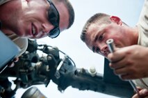 U.S. Air Force Airman 1st Class Errol Crossman, 723d Aircraft Maintenance Squadron crew chief, left, and Senior Airman Jason Conner, 41st Helicopter Maintenance Unit aerospace propulsion journeyman, finish the installation of an HH-60G Pave Hawk engine inlet July 31, 2012, at Moody Air Force Base, Ga. The Airmen removed the inlet to get to the engine’s drive shaft. (U.S. Air Force photo by Staff Sgt. Jamal D. Sutter/Released)  