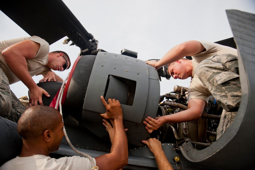 Airmen of the 723d Aircraft Maintenance Squadron and 41st Helicopter Maintenance Unit install an HH-60G Pave Hawk v-band clamp July 31, 2012, at Moody Air Force Base, Ga. The installation was one of the last steps in balancing an engine drive shaft, which prevents unsafe vibrations within the aircraft that can loosen screws during flight. (U.S. Air Force photo by Staff Sgt. Jamal D. Sutter/Released) 