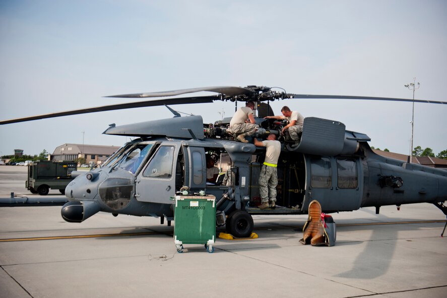 Airmen of the 723d Aircraft Maintenance Squadron and 41st Helicopter Maintenance Unit, install an HH-60G Pave Hawk engine inlet July 31, 2012, at Moody Air Force Base, Ga. The installation was part of a process that also involved an engine input module change and an engine drive shaft balance. The total process typically takes up to 12 hours to complete. (U.S. Air Force photo by Staff Sgt. Jamal D. Sutter/Released)  