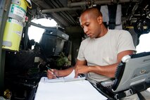 U.S. Air Force Airman 1st Class Michael Lewis, 23d Aircraft Maintenance Squadron aircraft hydraulics journeyman, completes paperwork during an HH-60G Pave Hawk engine drive shaft balance July 31, 2012, at Moody Air Force Base, Ga. Lewis documented each step of the process to ensure proper procedures were followed and accounted for. (U.S. Air Force photo by Staff Sgt. Jamal D. Sutter/Released) 