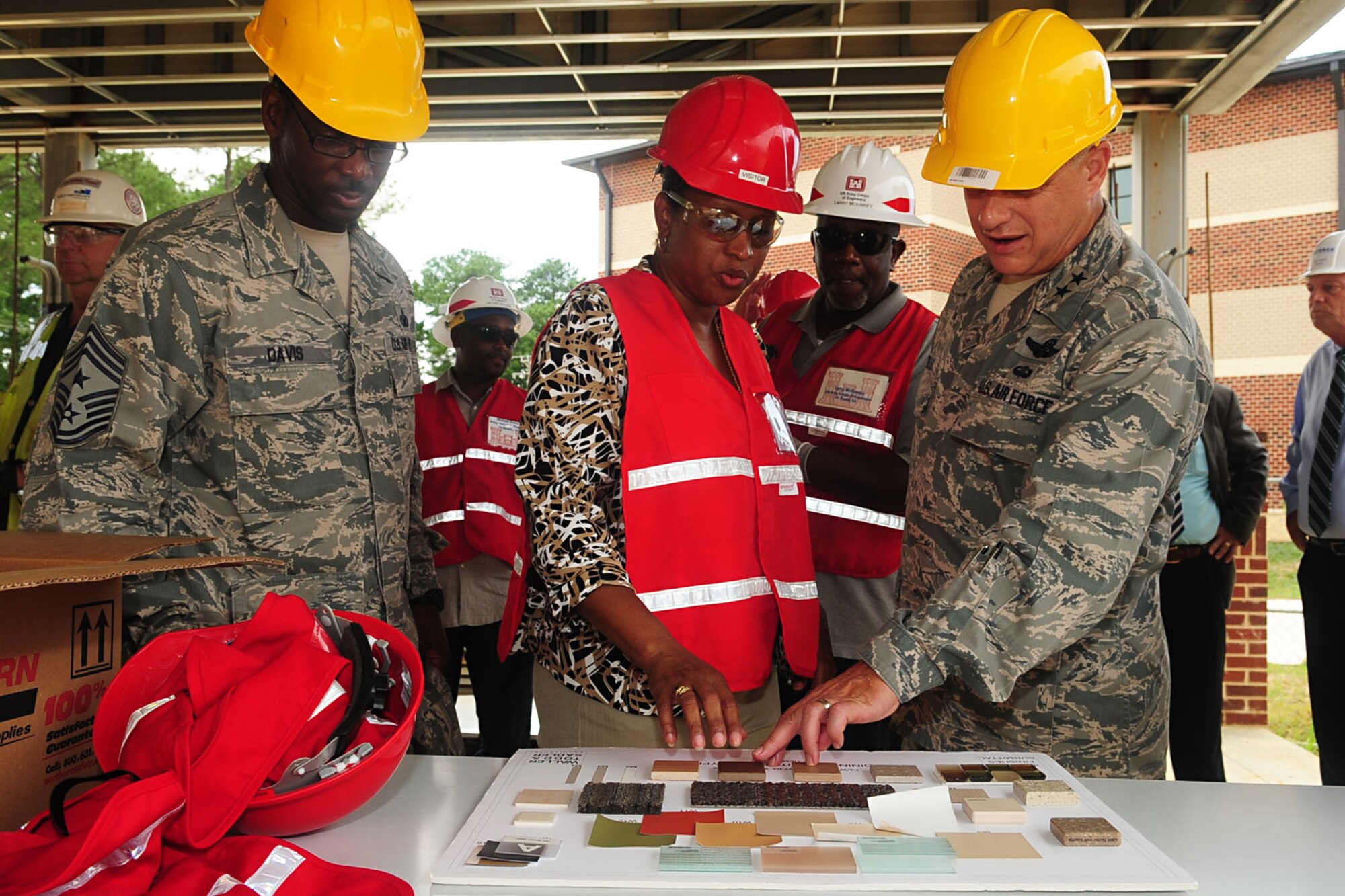 Delsa Green, (center) 733rd Logistics Readiness Division food program manager, explains the prototype of the new Advanced Individual Training dining facility to U.S. Air Force Maj. Gen. Lawrence Wells, 9th Air Force commander (right) and Chief Master Sgt. James Davis, 9th AF command chief, during a tour at Fort Eustis, Va., Aug. 1, 2012. Wells and Davis toured Joint Base Langley-Eustis to assess the standard of living of all personnel on both installations. (U.S. Air Force photo by Staff Sgt. Ashley Hawkins/Released)