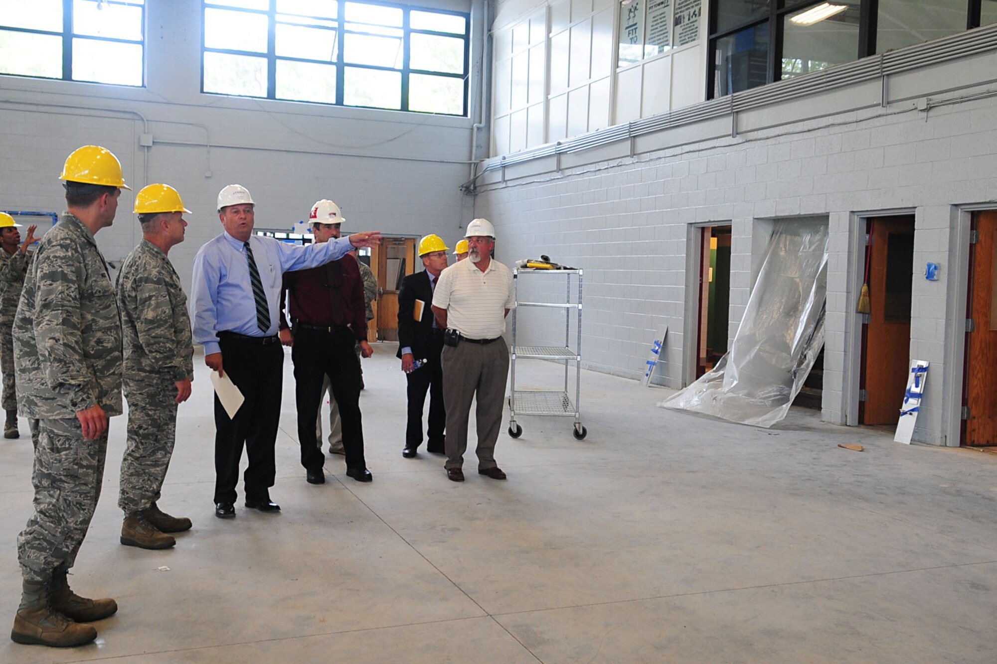 John Volkers, (center) Fort Eustis Morale, Welfare and Recreation director, shows U.S. Air Force Maj. Gen. Lawrence Wells, 9th AF commander, the continuing construction of Anderson Field House during a tour at Fort Eustis, Va., Aug. 1, 2012. Wells visited Joint Base Langley-Eustis to evaluate the standard of living for the Soldiers and Airmen. (U.S. Air Force photo by Staff Sgt. Ashley Hawkins/Released)