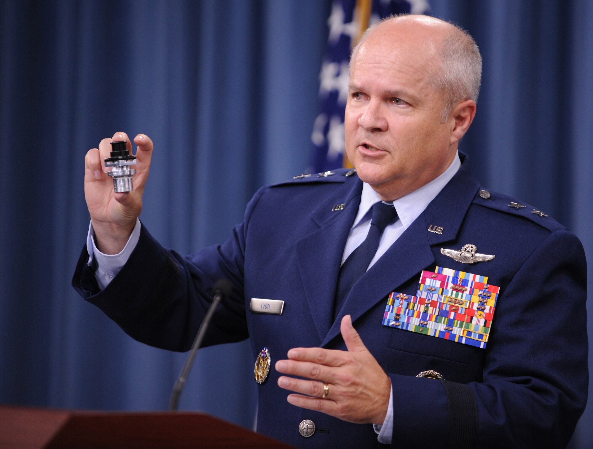 Maj. Gen. Charles Lyon speaks about a new valve that regulates the proper flow of oxygen to an F-22 Raptor pilot’s vest in Washington, D.C., July 31, 2012. The valve will begin testing next month and should be installed by the end of the year. Lyon is the director of operations at Headquarters Air Combat Command. (U.S. Air Force photo/Senior Airman Christina Brownlow)