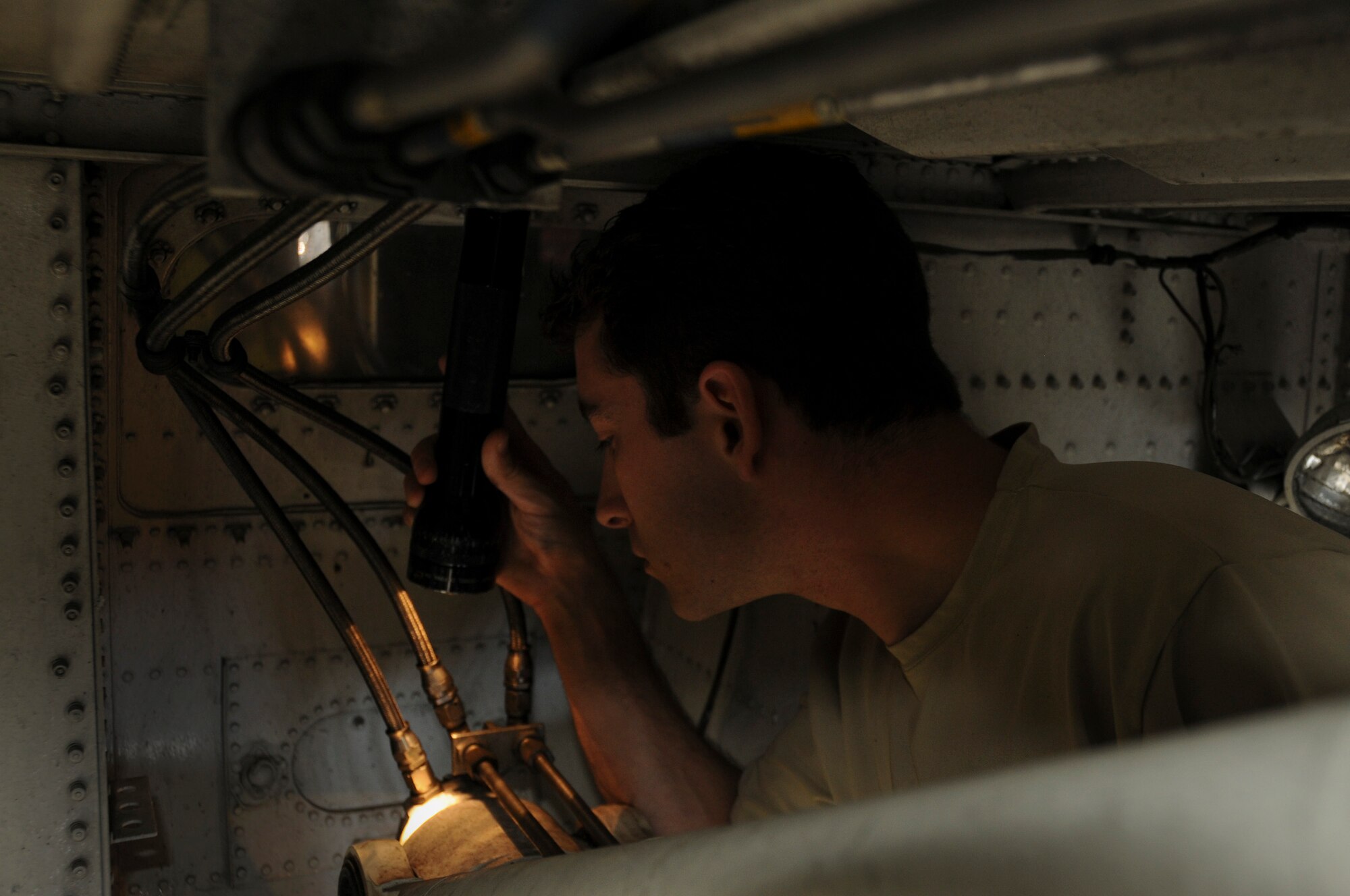 Tech. Sgt. Richard Witherite, a 911th Airlift Wing Maintenance Squadron isochronal inspection aircraft mechanic, inspects the nose landing gear actuator’s aft plunger for fluorescent paint, here, July 31, 2012. When visible, the fluorescent paint shows the flight crew that the landing gear is down and locked, meaning it is safe for the aircraft to land. (U.S. Air Force photo by Senior Airman Joshua J. Seybert/Released)