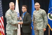 Col. Robert Bridgford, 502nd Air Base Wing vice commander and Joint Base San Antonio deputy commander, accompanied by Chief Master Sgt. Jose LugoSantiago, 502nd ABW and JBSA command chief master sergeant, give Christopher Underwood, 502nd Comptroller Squadron financial analyst flight chief, the Civilian Supervisory Category II of the Quarter award during the 502nd ABW 2nd Quarter Awards at the Randolph Kendrick Club Aug. 1.
(U.S. photo by Benjamin Faske)

