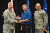 Col. Robert Bridgford, 502nd Air Base Wing vice commander and Joint Base San Antonio deputy commander, accompanied by Chief Master Sgt. Jose LugoSantiago, 502nd ABW and JBSA command chief master sergeant, give Donald Martin, 902nd Contracting Squadron Information Technology project manager, the Civilian Non-Supervisory Category III of the Quarter award during the 502nd ABW 2nd Quarter Awards at the Randolph Kendrick Club Aug. 1.
(U.S. photo by Benjamin Faske)
