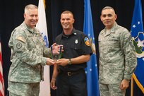 Col. Robert Bridgford, 502nd Air Base Wing vice commander and Joint Base San Antonio deputy commander, accompanied by Chief Master Sgt. Jose LugoSantiago, 502nd ABW and JBSA command chief master sergeant, give Jeffery Sgro, 502nd Civil Engineer Squadron firefighter and basic life support emergency medical technician, the Civilian Non-Supervisory Category II of the Quarter award during the 502nd ABW 2nd Quarter Awards at the Randolph Kendrick Club Aug. 1.
(U.S. photo by Benjamin Faske)
