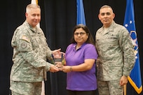 Col. Robert Bridgford, 502nd Air Base Wing vice commander and Joint Base San Antonio deputy commander, accompanied by Chief Master Sgt. Jose LugoSantiago, 502nd ABW and JBSA command chief master sergeant, give Gloria Perez, 802nd Logistics Readiness Squadron supply technician, the Civilian Non-Supervisory Category I of the Quarter award during the 502nd ABW 2nd Quarter Awards at the Randolph Kendrick Club Aug. 1.
(U.S. photo by Benjamin Faske)

