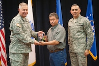 Col. Robert Bridgford, 502nd Air Base Wing vice commander and Joint Base San Antonio deputy commander, accompanied by Chief Master Sgt. Jose LugoSantiago, 502nd ABW and JBSA command chief master sergeant, give Eloy Diaz, 802nd Civil Engineer Squadron maintenance mechanic, the Civilian Wage Grade of the Quarter award during the 502nd ABW 2nd Quarter Awards at the Randolph Kendrick Club Aug. 1.
(U.S. photo by Benjamin Faske)
