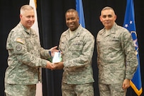 Col. Robert Bridgford, 502nd Air Base Wing vice commander and Joint Base San Antonio deputy commander, accompanied by Chief Master Sgt.Jose LugoSantiago, 502nd ABW and JBSA command chief master sergeant, give Capt. Jonathan Runnels, 502nd Air Base Wing chaplain, the Company Grade Officer of the Quarter award during the 502nd ABW 2nd Quarter Awards at the Randolph Kendrick Club Aug. 1.
(U.S. photo by Benjamin Faske)

