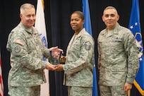 Col. Robert Bridgford, 502nd Air Base Wing vice commander and Joint Base San Antonio deputy commander, accompanied by Chief Master Sgt. Jose LugoSantiago, 502nd ABW and JBSA command chief master sergeant, give Master Sgt. Christina Warner, 802nd Mission Support Group contracting superintendent, the Senior Enlisted Member of the Quarter award during the 502nd ABW 2nd Quarter Awards at the Randolph Kendrick Club Aug. 1.
(U.S. photo by Benjamin Faske)
