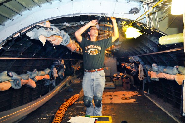 John Hatfield, performs a main frame visual inspection in the troop compartment of the C-5M at Robins. (U. S. Air Force photo/Sue Sapp)