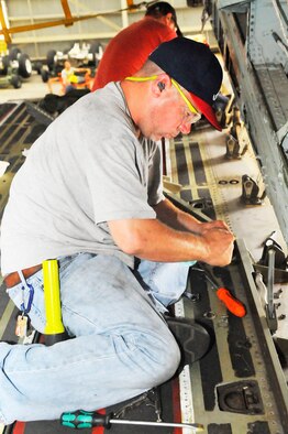 Tim Swift performs an aft ramp inspection on the C-5M at Robins.(U. S. Air Force photo/Sue Sapp)