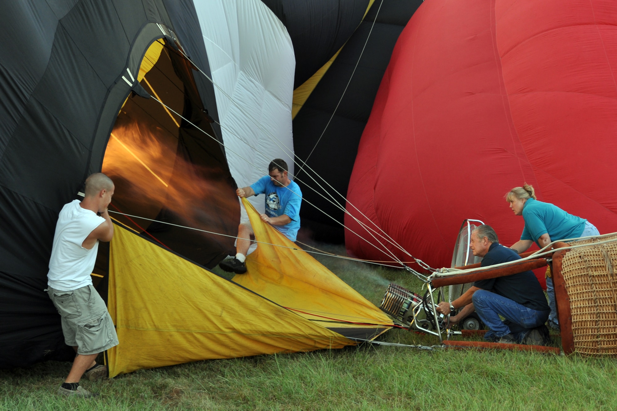 Balloon team members inflate their balloon with hot air during the Great Texas Balloon Race 2012, at the East Texas Regional Airport in Longview, Texas, July 28, 2012. For the first time in the 35-year history of the event, the U.S. National Championships were held in conjunction with the annual event. (U.S. Air Force photo by Master Sgt. Jeff Walston)