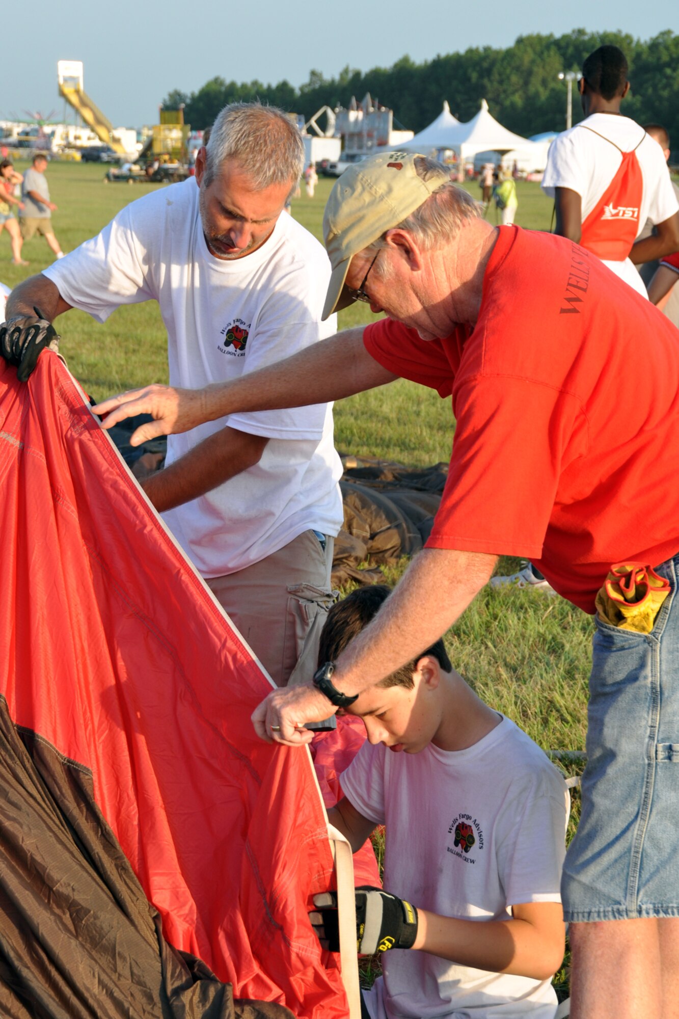Members of the Wells Fargo Hot Air Balloon Team prepare their balloon to be inflated during the Great Texas Balloon Race 2012, at East Texas Regional Airport in Longview, Texas, July 28, 2012. For the first time in the 35-year history of the event, the U.S. National Championships were held in conjunction with the annual event. (U.S. Air Force photo by Master Sgt. Jeff Walston)    
