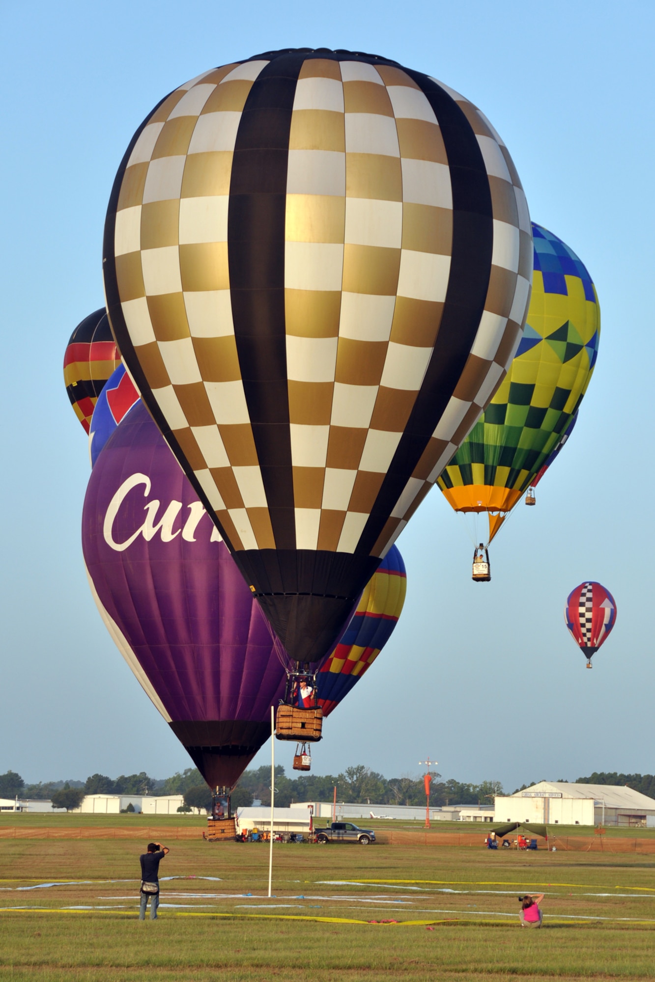 A hot air balloon pilot acknowledges his perfect aim in the Ring Toss Competition during the Great Texas Balloon Race 2012, at the East Texas Regional Airport in Longview, Texas, July 28, 2012. For the first time in the 35-year history of the event, the U.S. National Championships were held in conjunction with the annual event. (U.S. Air Force photo by Master Sgt. Jeff Walston)    