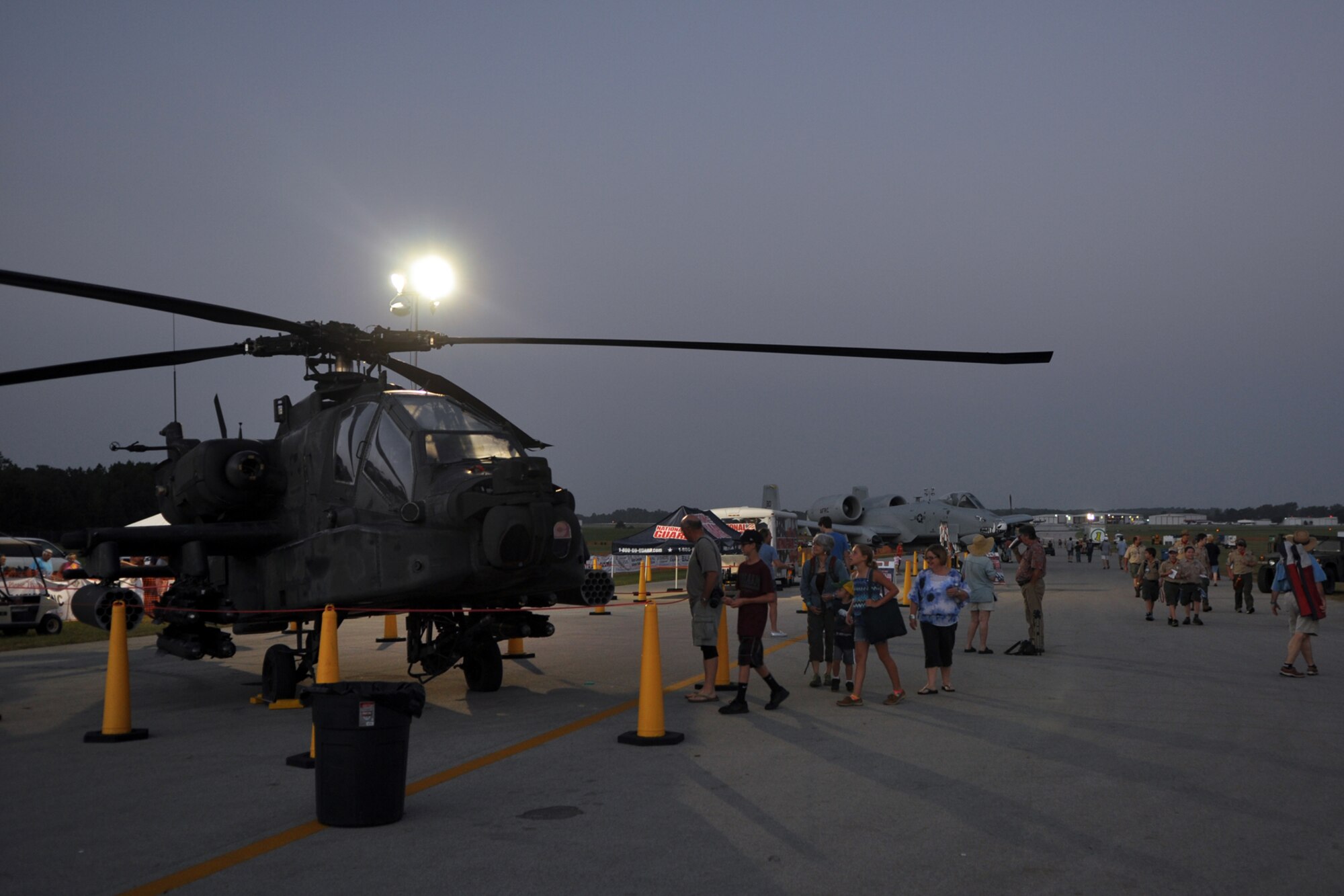 A Texas Army National Guard AH-64A Apache Attack Helicopter from the 1-149th Attack Reconnaissance Battalion, Ellington Field Joint Reserve Base, Houston, Texas, and an A-10 Thunderbolt II from the 47th Fighter Squadron, 917th Fighter Group at Barksdale Air Force Base, La., wait for the crowds at the East Texas Regional Airport in Longview, Texas, July 28, 2012. The aircraft were static displays at the Great Texas Balloon Race 2012. The crew of the AH-64A apache was Maj. Randal Wright, pilot in command and 1st Lt. Ben Hickman, pilot, from Ellington Field. The A-10 was piloted by Maj. Jason Cobb, who is assigned to the 47 FS, Barksdale AFB, La. (U.S. Air Force photo by Master Sgt. Jeff Walston)    