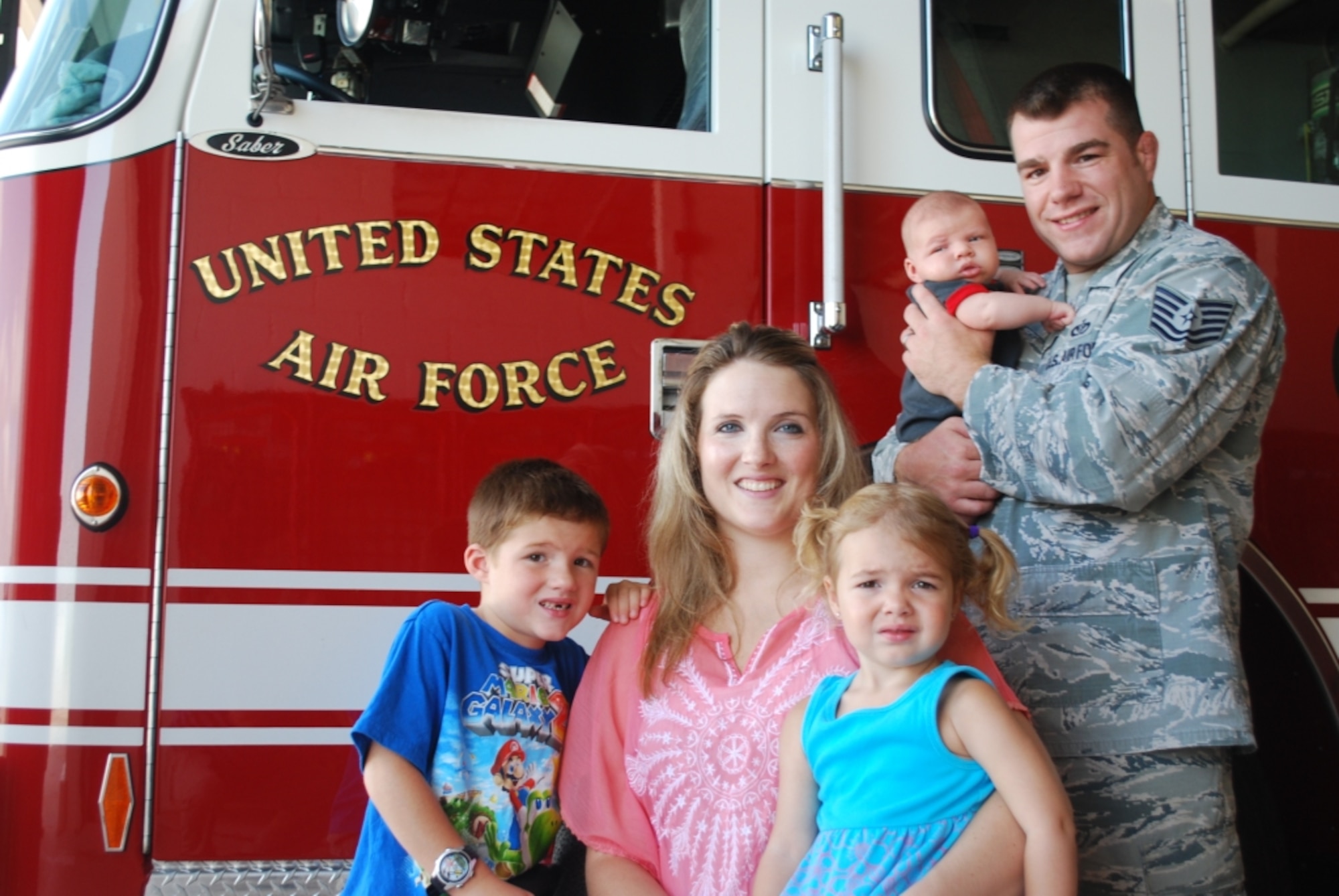 Tech. Sgt. Chad Malley, 45th Civil Engineer Squadron, holding 5-week old son, Cais, had quite the experience with his wife, Tye, with Connor, 6, and Cadence, 3. Chad, recently selected for promotion to Master Sgt, used his Air Force training as a firefighter and EMT, to help his wife deliver their son in a convenience store parking lot on the way to the hospital. (Photo by Chris Calkins)