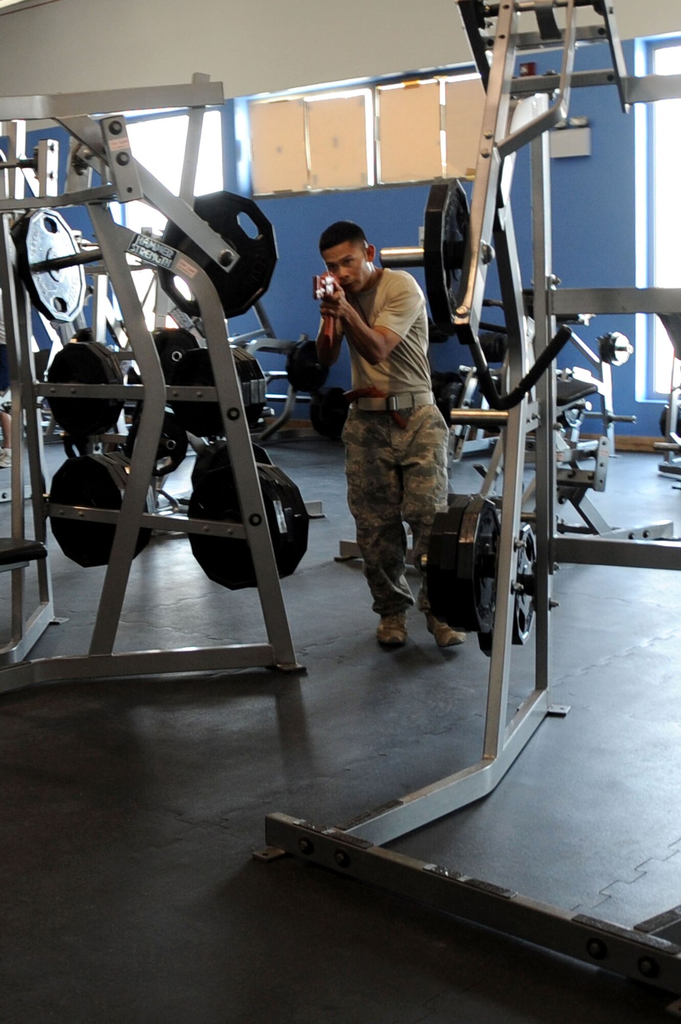 U.S. Air Force Staff Sgt. Angelo DeMesa, 379th Expeditionary Security Forces Squadron instructor, simulates a shooting spree as an active shooter during exercise inside the BPC fitness center in Southwest Asia, July 30, 2012. The active shooter exercise tested the defense and response capabilities of U.S. service members on the installation. DeMesa is deployed from Joint Base Lewis-McChord, Wash., and is a native of Angeles City, Philippines. (U.S. Air Force photo/Staff Sgt. Sheila deVera)