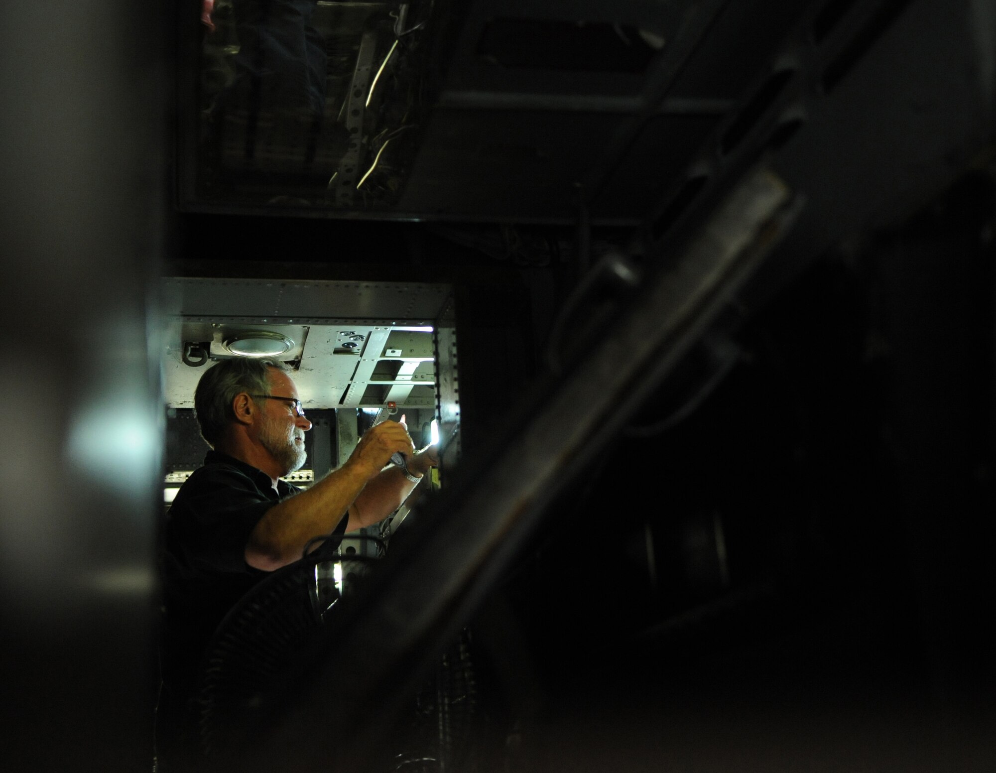 Larry Cook, VSE Corporation aircraft mechanic III, installs wiring for a Sniper pod targeting system in a B-52H Stratofortress on Barksdale Air Force Base, La., Aug. 1. Barksdale is scheduled to receive the new targeting system by May, 2013. To prepare for the new technology, aircraft are being rewired so they can support the Sniper pods when they arrive. (U.S. Air Force photo/Airman 1st Class Micaiah Anthony)(RELEASED)