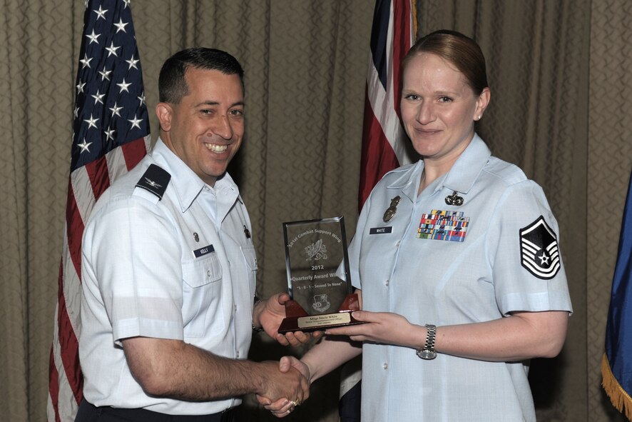RAF ALCONBURY, United Kingdom - Col. Brian Kelly, 501st Combat Support Wing commander, presents the SNCO of the Quarter for Master. Sgt. Stacie White, 423rd Air Base Group. (U.S. Air Force photo by Master Sgt. John Barton)