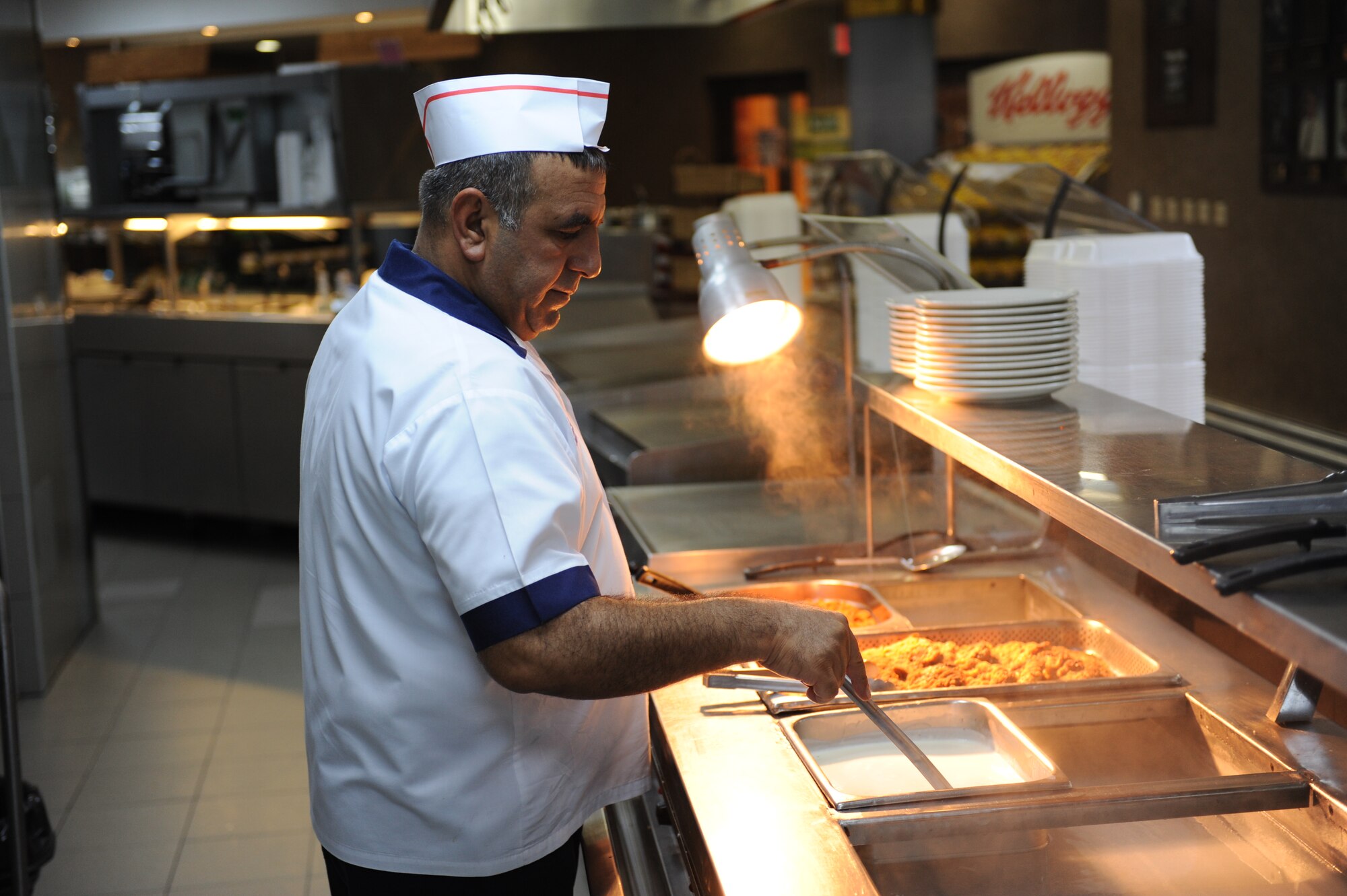Osman Sendag, 39th Force Support Squadron apprentice cook, makes final preparations prior to the dining facility opening for lunch July 27, 2012 at the  Sultan's Inn Dining Facility at Incirlik Air Base, Turkey. The facility offers a main line, short order line, and a variety of made-to-order foods such as sandwiches and  chicken at lunch.(U.S. Air Force photo by Senior Airman William A. O'Brien/Released) 